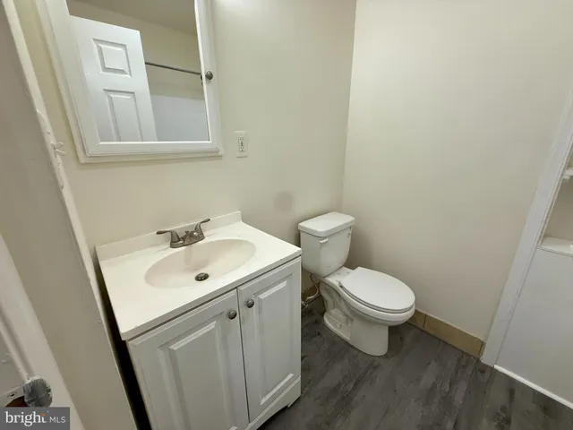 a white toilet sitting next to a bathroom sink