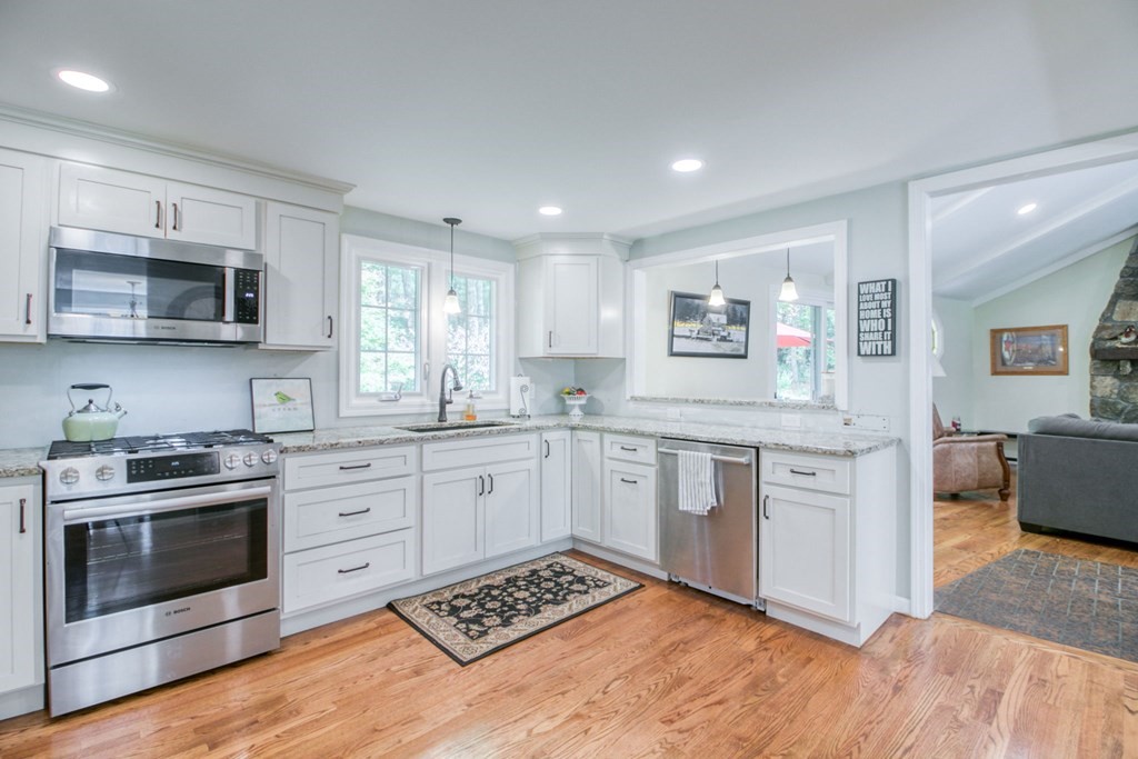 27 Thayer Road Monson, MA 01057 - Photo 9 of 39 a kitchen with granite countertop a stove top oven sink and cabinets