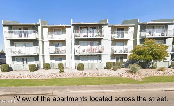 a front view of a residential apartment building with a yard