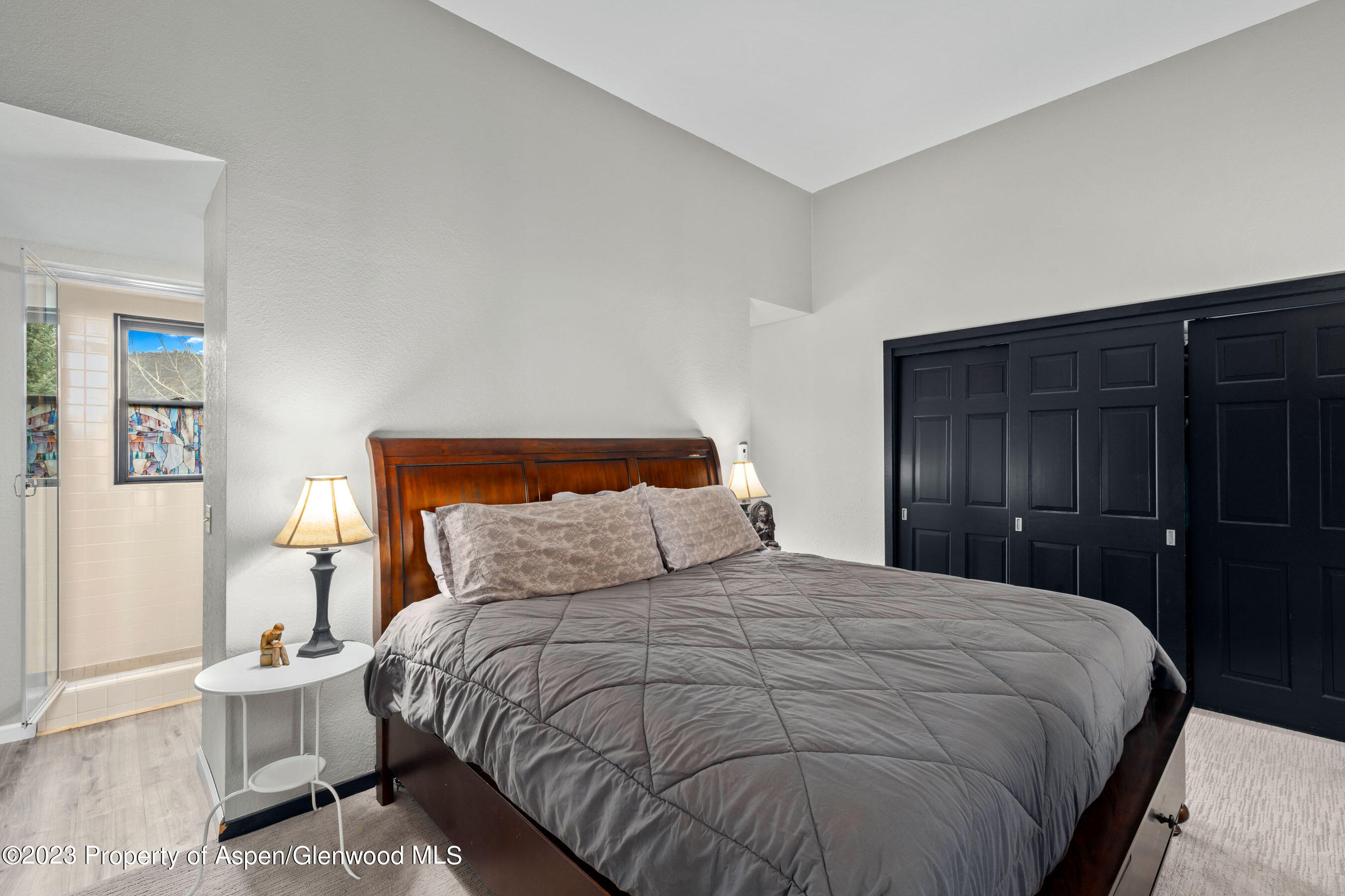 425 Wood Road, Unit 6 Snowmass Village, CO 81615 - Photo 16 of 29 a bedroom with a bed and a night stand