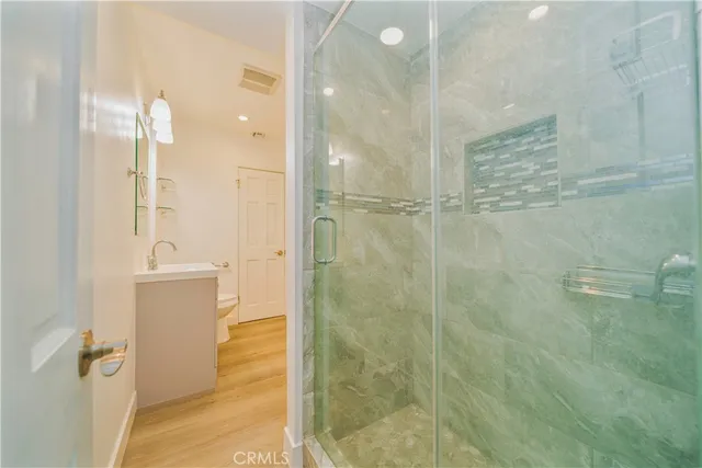 a bathroom with a shower and a sink