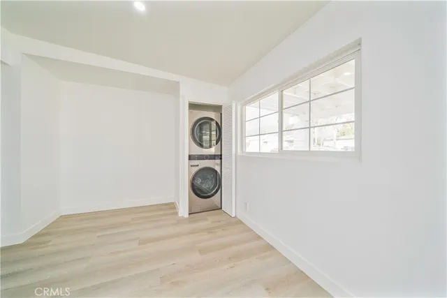 a view of a storage and utility room with washer and dryer