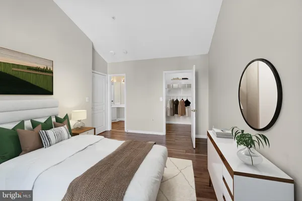 a spacious bedroom with a large bed and a flat screen tv