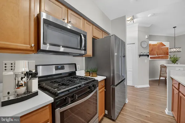 a kitchen with stainless steel appliances granite countertop a stove and a refrigerator