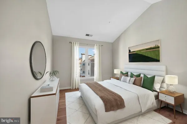 a bedroom with furniture and a flat screen tv
