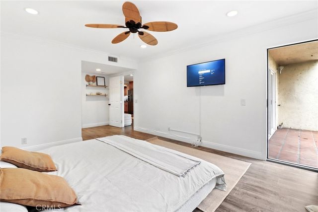a bedroom with a bed and a ceiling fan
