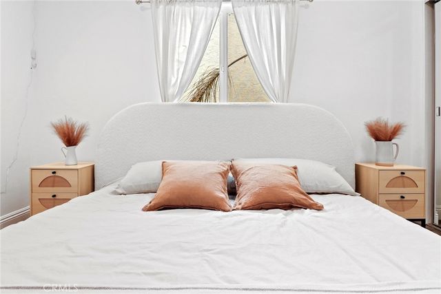 a bedroom with a bed and a window