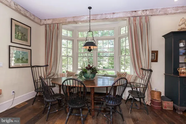 a view of a dining room with furniture wooden floor and chandelier