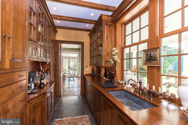 a living room with furniture a fireplace and a large window
