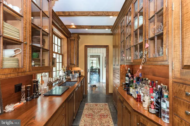 a living room with furniture a fireplace and a chandelier