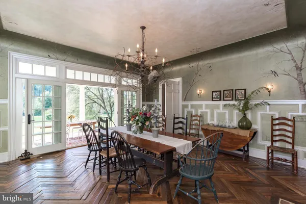 a living room with a black white checkered floor with a black white checkered floor and a potted plant