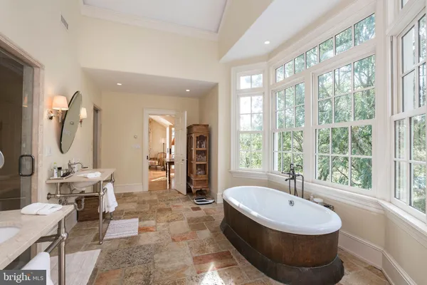 a room with pool table and windows
