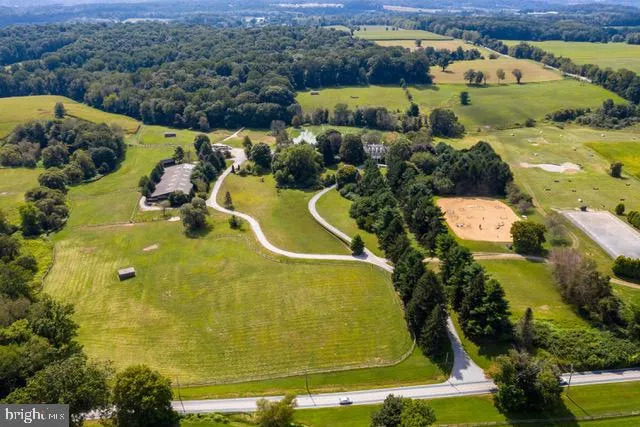 a kitchen with stainless steel appliances granite countertop a table chairs and wooden floor