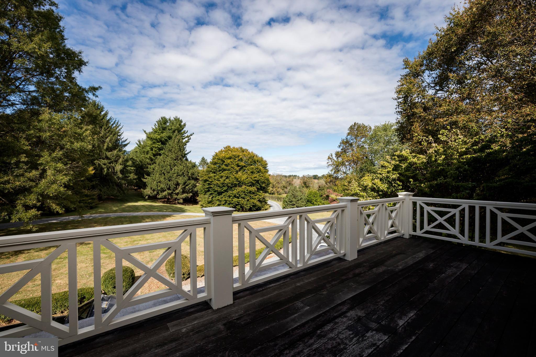 380 Upland Road Kennett Square, PA 19348 - Photo 47 of 106 a view of a balcony with wooden floor and iron fence