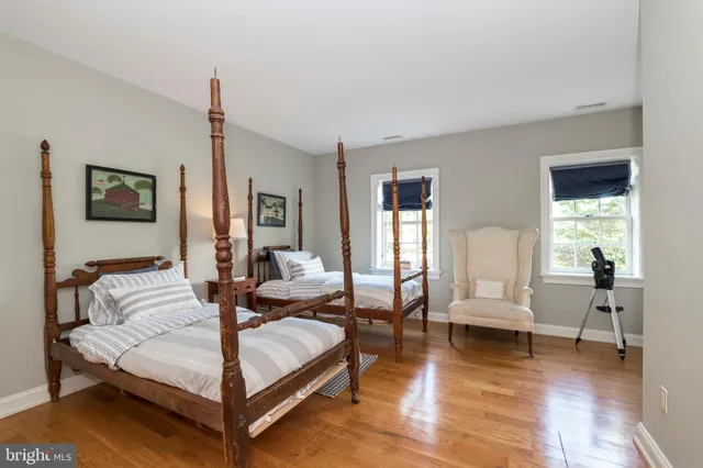 a view of a house with a yard and potted plants