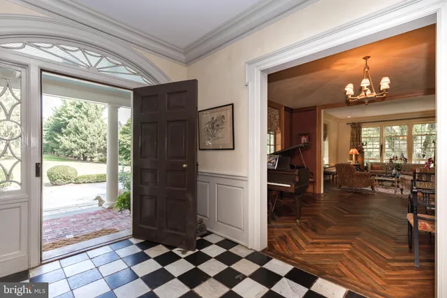 a dining room with wooden floor and large window