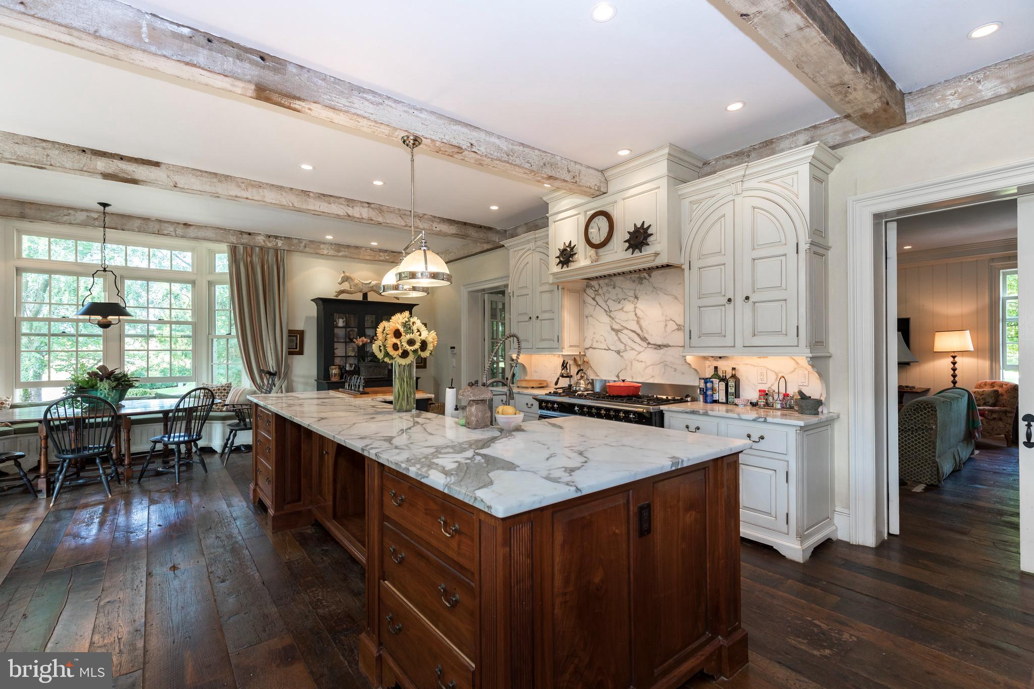 380 Upland Road Kennett Square, PA 19348 - Photo 8 of 106 a kitchen with stainless steel appliances granite countertop a table chairs and wooden floor