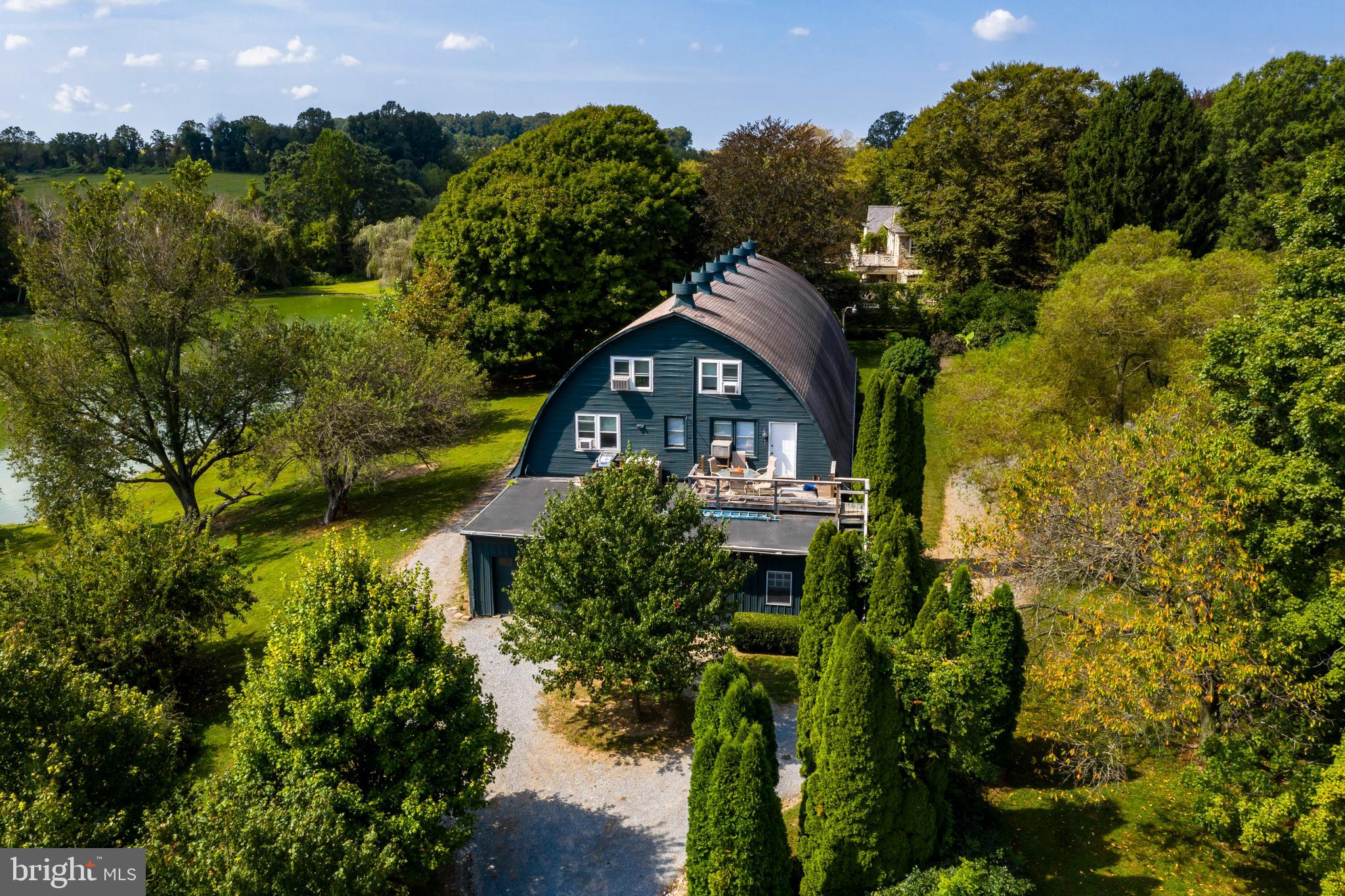 380 Upland Road Kennett Square, PA 19348 - Photo 95 of 106 a view of a house with a yard and potted plants