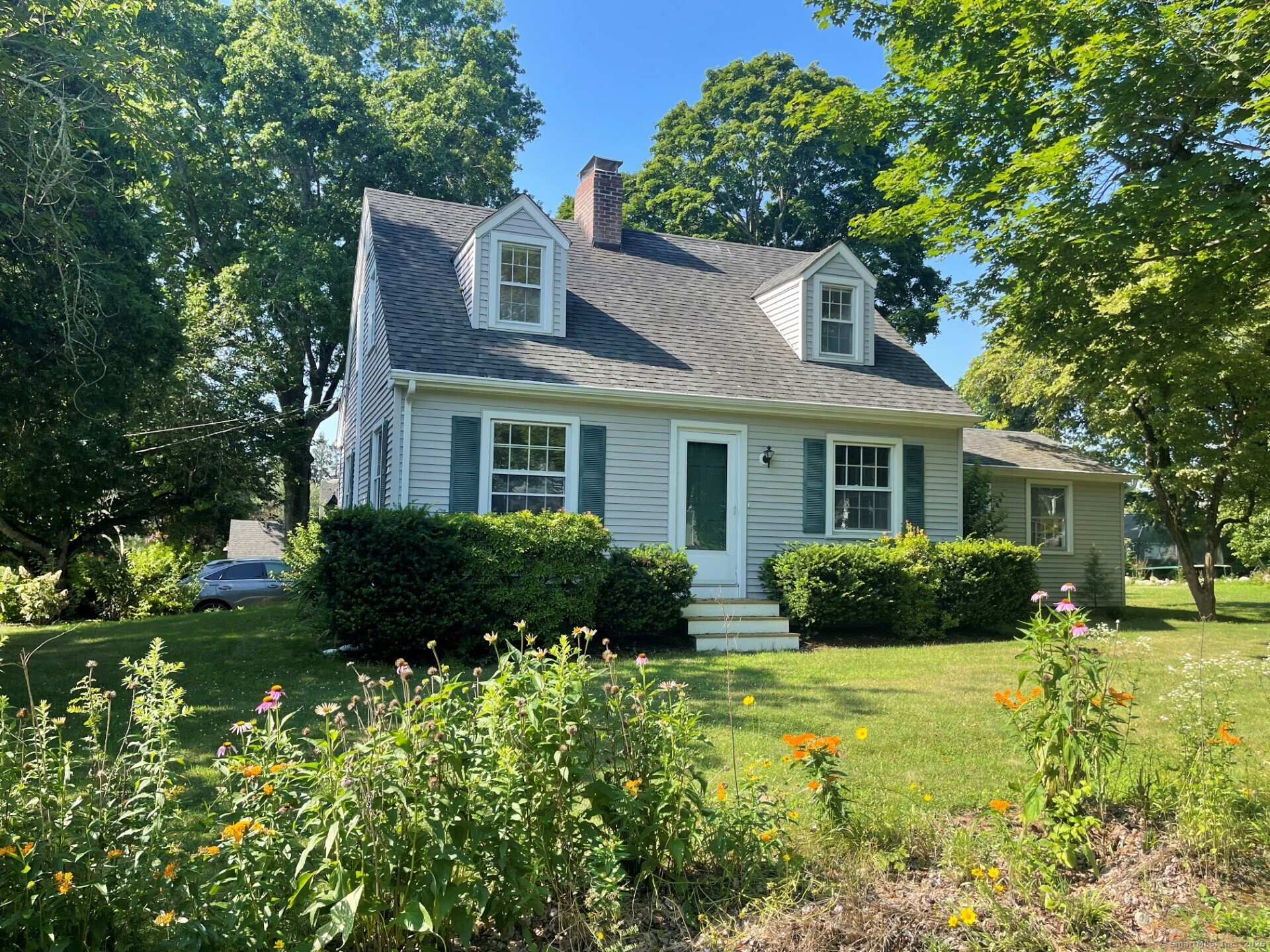 99 Bay View Avenue Groton, CT 06355 - Photo 1 of 34 a front view of a house with a yard and outdoor seating