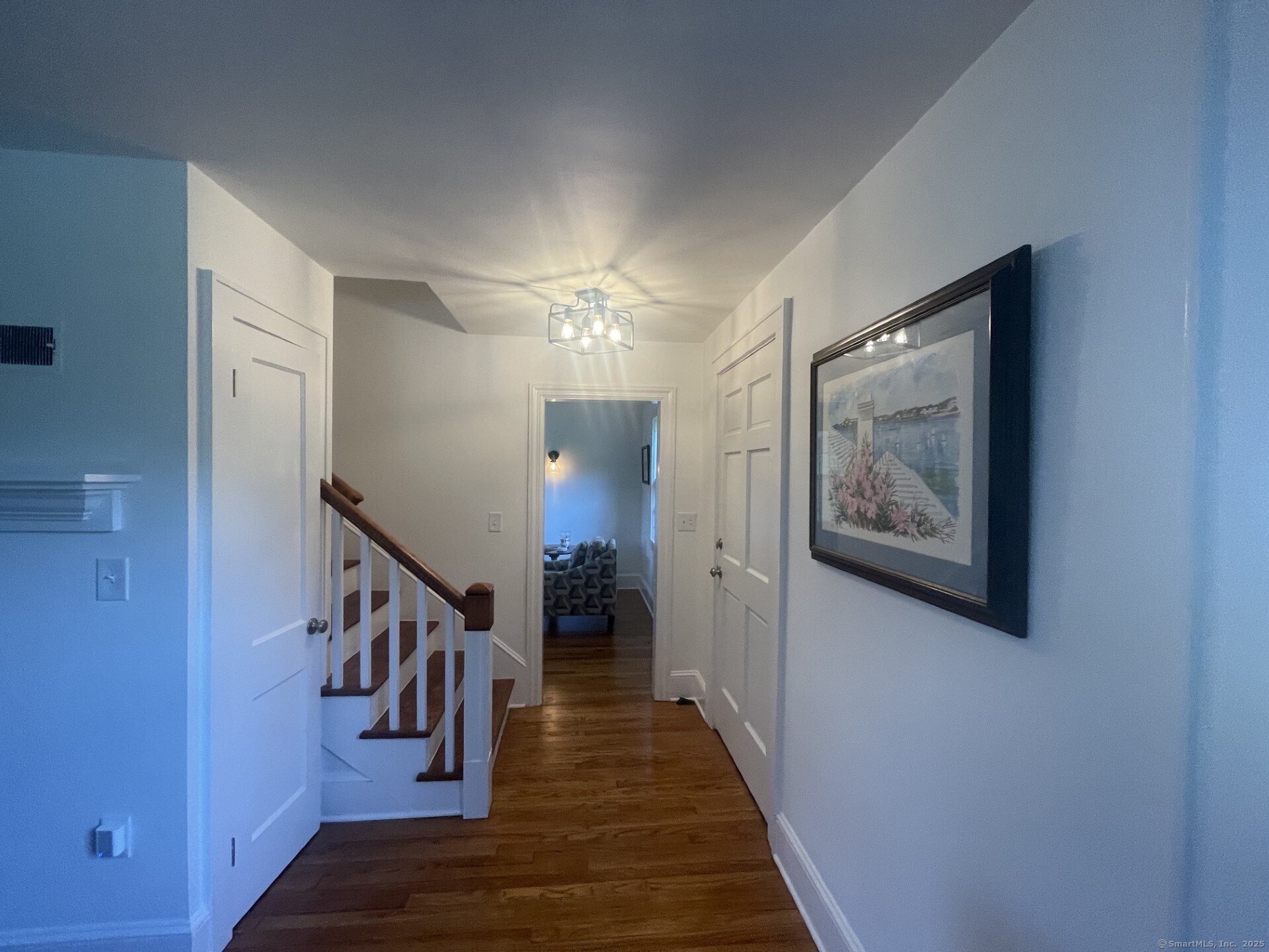 99 Bay View Avenue Groton, CT 06355 - Photo 44 of 70 a hallway with wooden floor chandelier and hallway