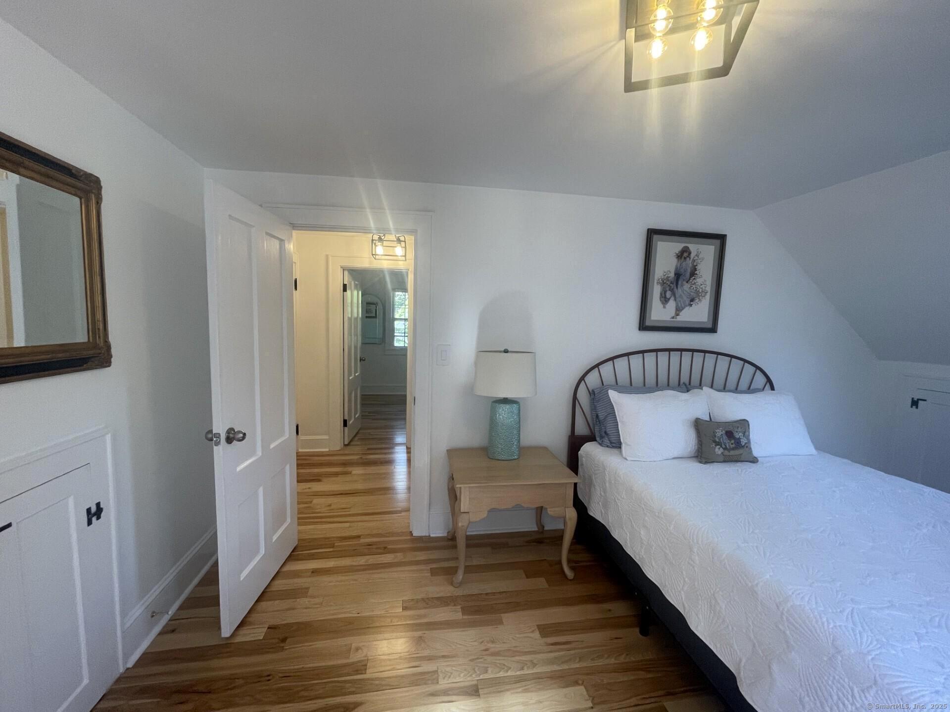 99 Bay View Avenue Groton, CT 06355 - Photo 57 of 70 a bedroom with a bed and a mirror