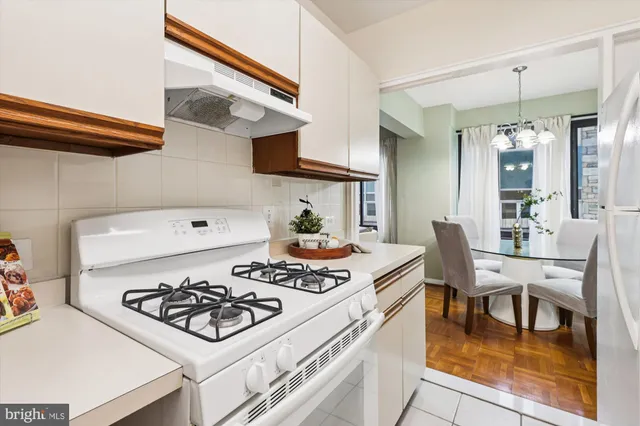 a kitchen with stainless steel appliances granite countertop a sink refrigerator and cabinets