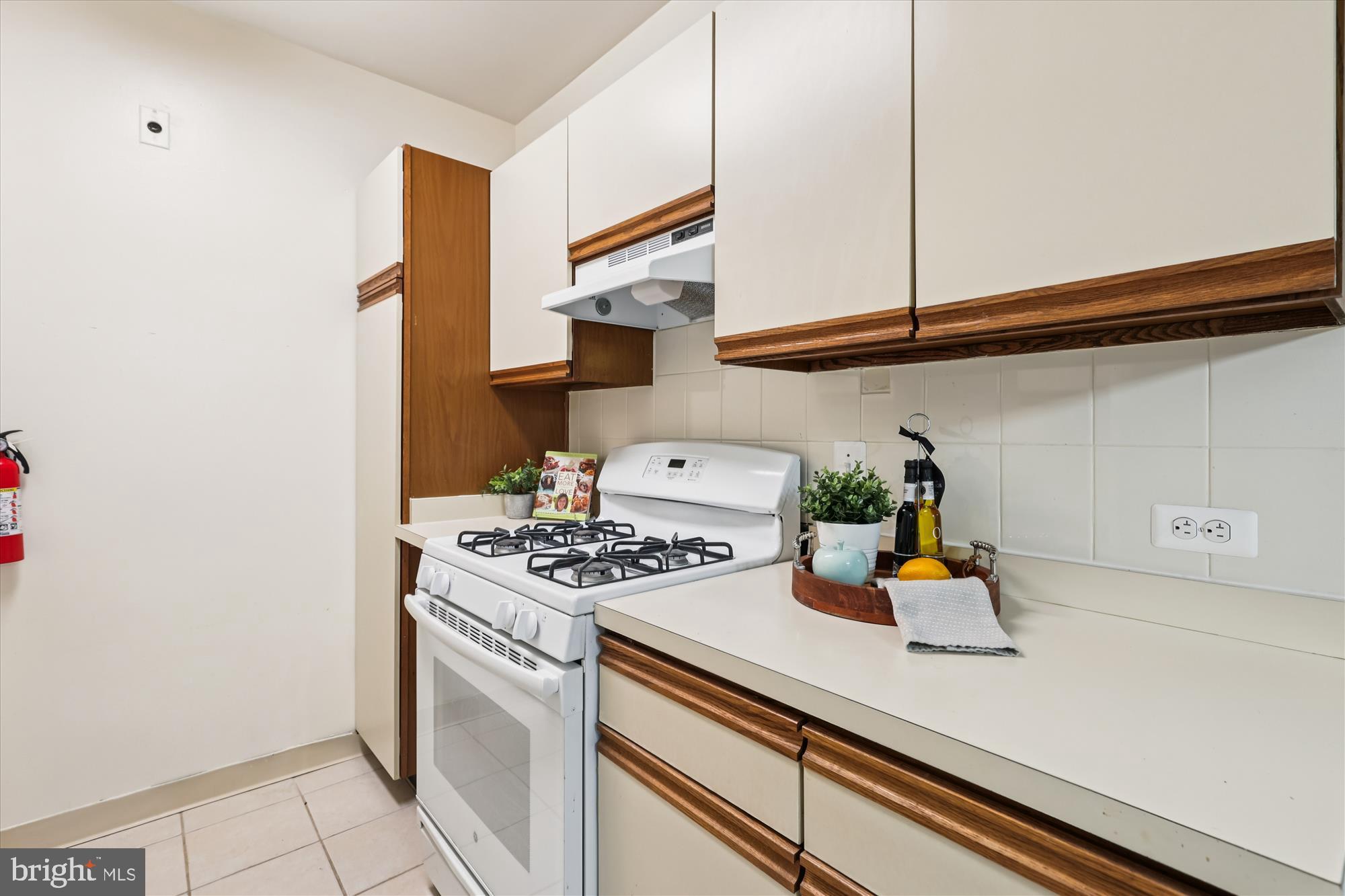 3601 Wisconsin Avenue Northwest, Unit 111 Washington, DC 20016 - Photo 16 of 82 a white kitchen with a sink and a stove