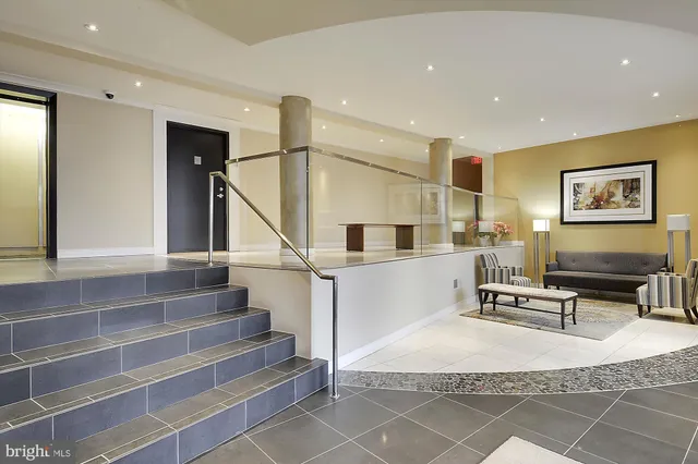 a living room with furniture and a chandelier
