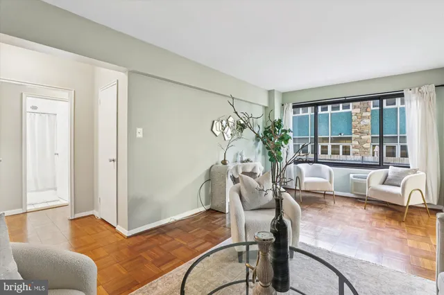 a living room with furniture and a large window