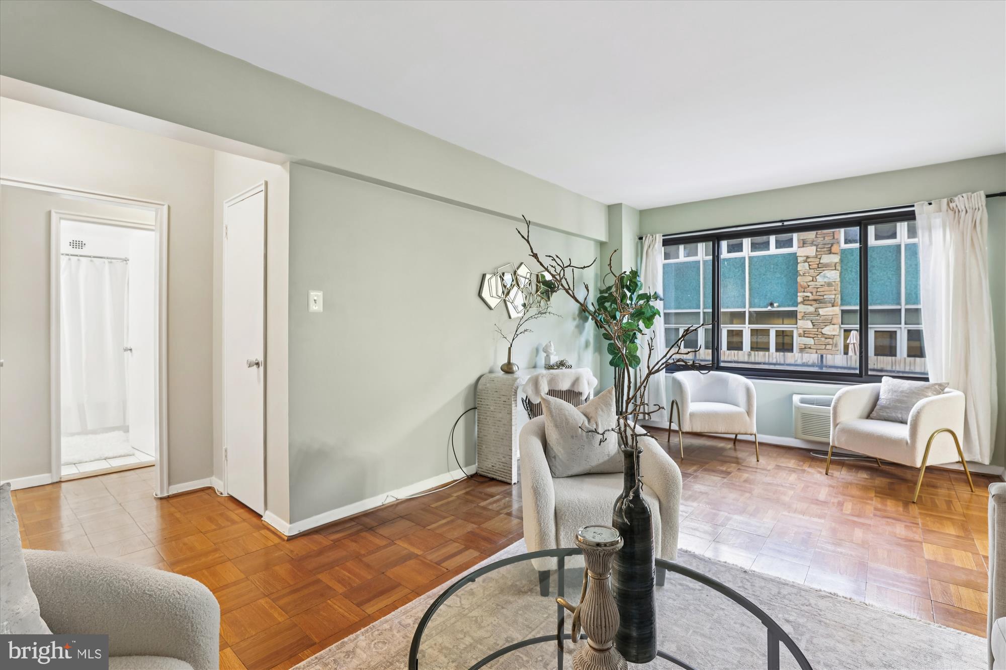 3601 Wisconsin Avenue Northwest, Unit 111 Washington, DC 20016 - Photo 8 of 82 a living room with furniture and a large window