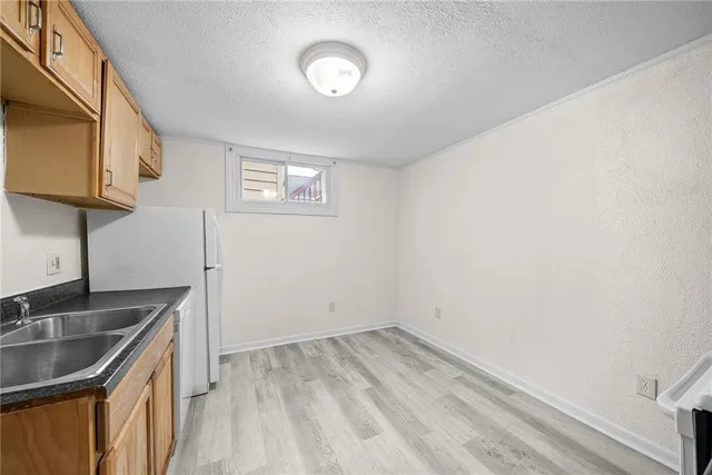 a view of a kitchen that shows a sink storage and utility