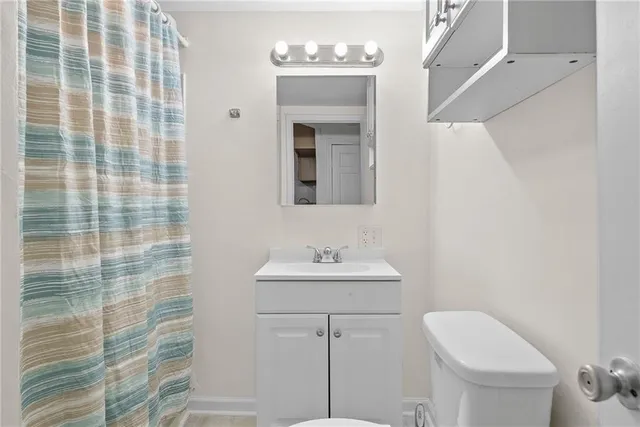 a bathroom with a sink a toilet and mirror
