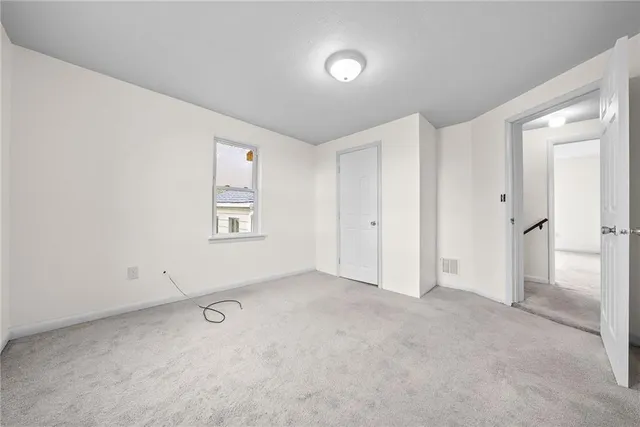 an empty room with a empty space and windows