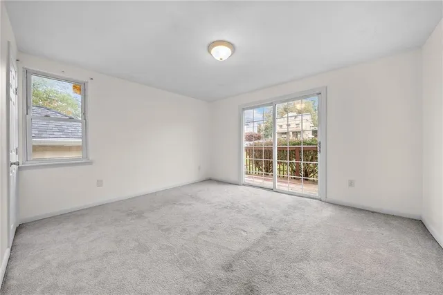 an empty room with windows and closet