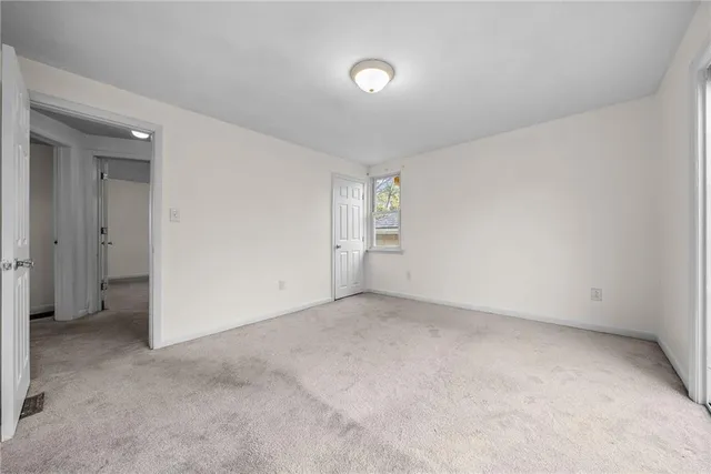 an empty room with a empty space and windows