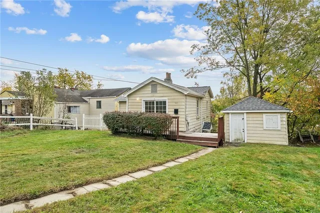 a front view of house with yard and green space