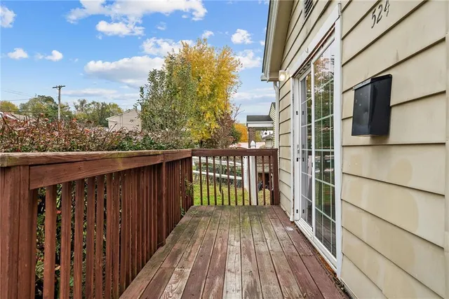 a balcony with wooden floor and fence