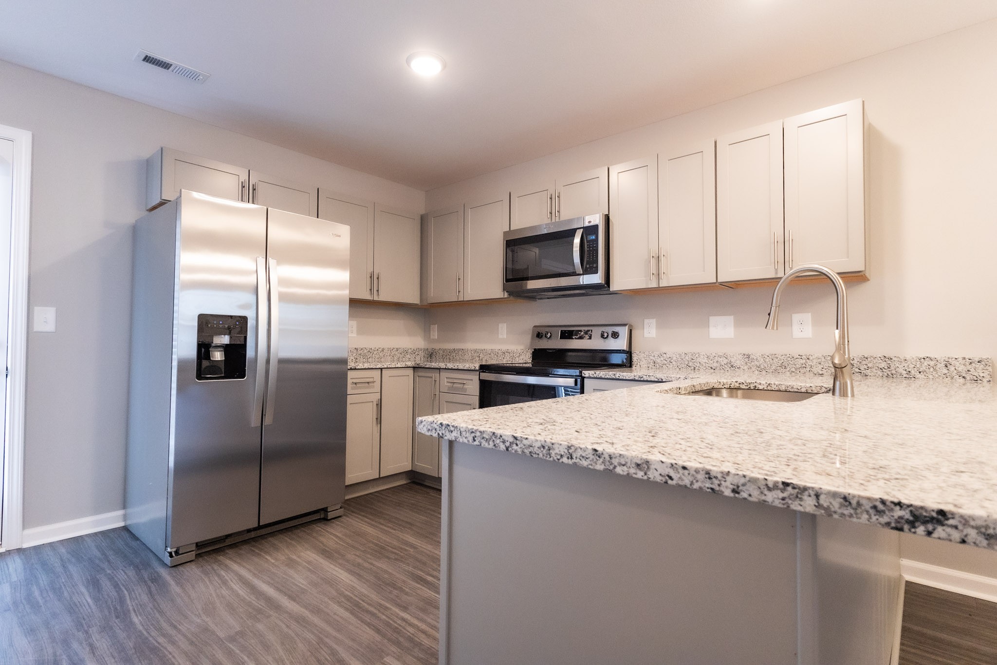 144 Davis Ridge Lane Clarksville, TN 37040 - Photo 6 of 26 a kitchen with granite countertop a refrigerator sink and microwave