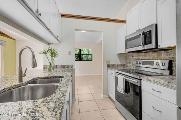 a kitchen with a stove microwave and sink