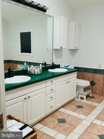 a spacious bathroom with a sink and a mirror