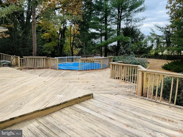 a view of balcony with wooden floor and fence