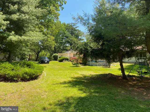 a view of a backyard with swimming pool