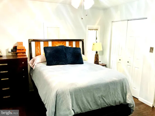 a bedroom with a bed and a night stand