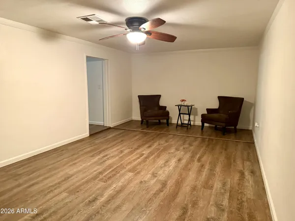 a view of a livingroom with furniture and a ceiling fan