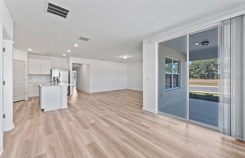 12627 Blue Reflection Avenue Parrish, FL 34219 - Photo 5 of 16 a view of a kitchen with wooden floor and a large window