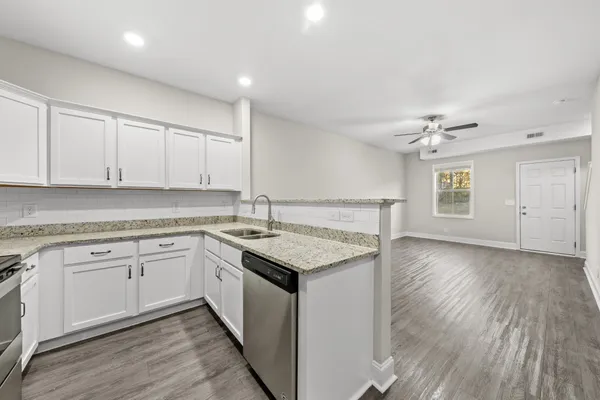 a kitchen with a sink stainless steel appliances and cabinets