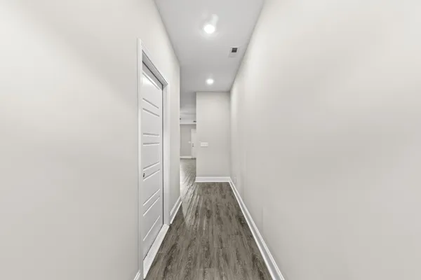 a view of hallway with wooden floor