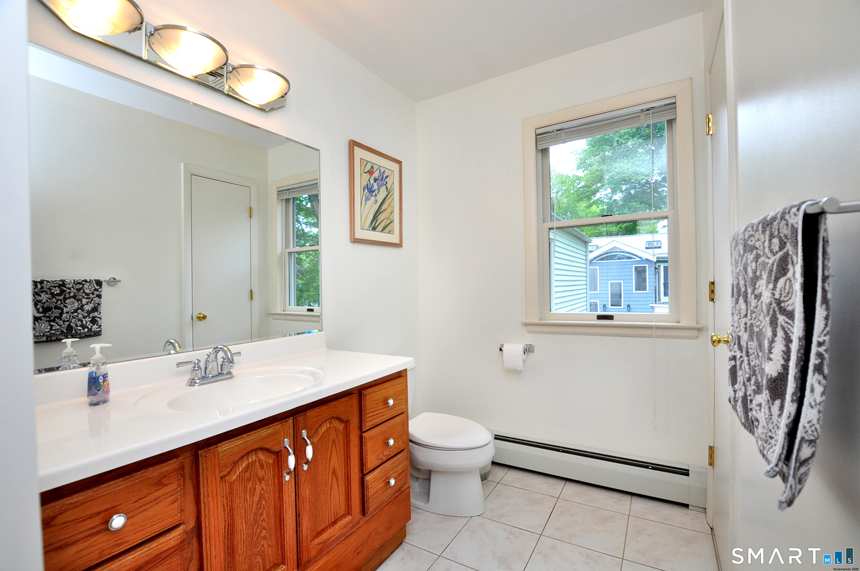 44 Miamis Road West Hartford, CT 06117 - Photo 30 of 39 a bathroom with a sink a toilet and mirror
