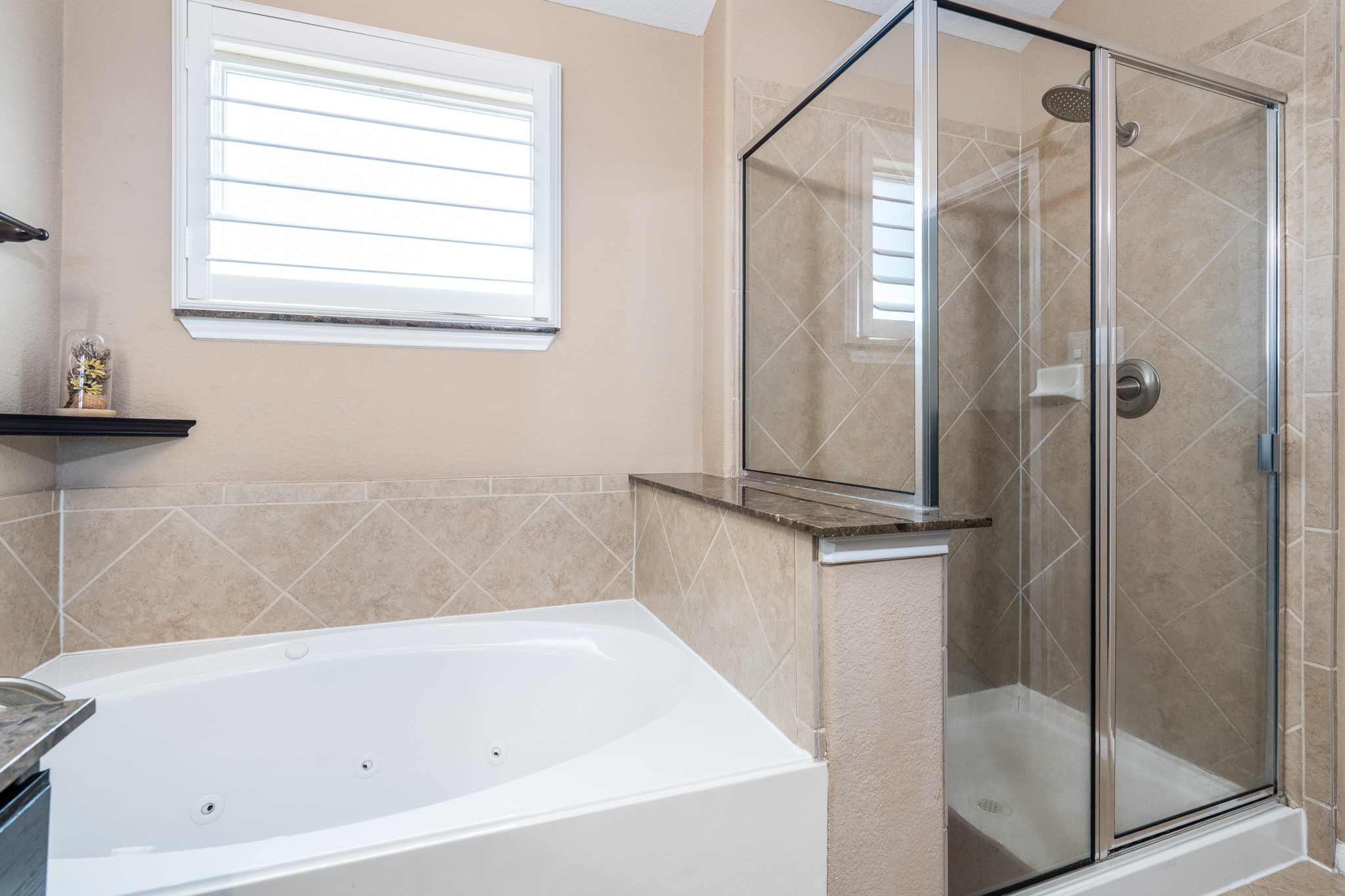 9115 Monarch Mist Lane Houston, TX 77070 - Photo 18 of 26 a bathroom with a bathtub and a shower