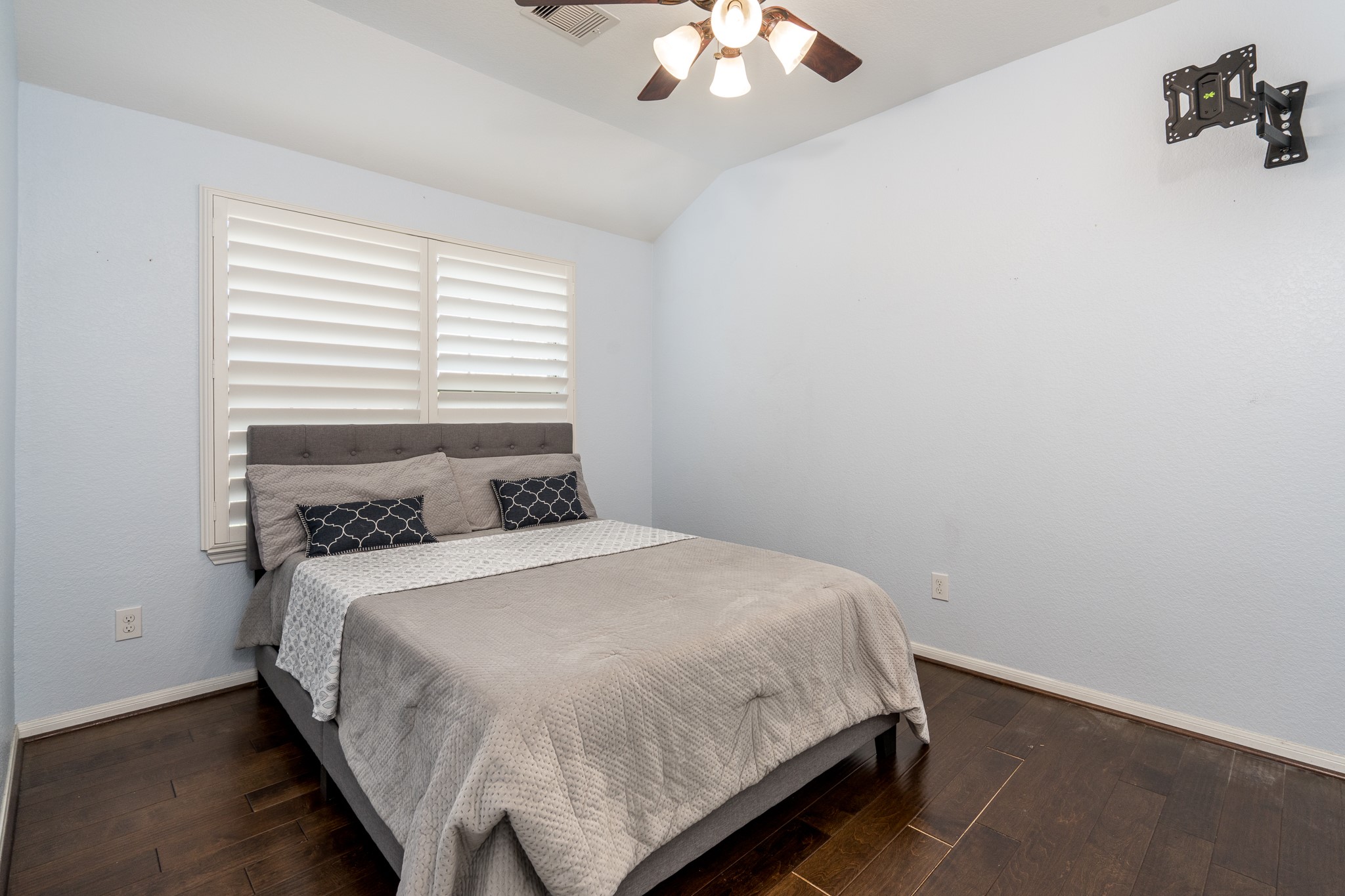 9115 Monarch Mist Lane Houston, TX 77070 - Photo 19 of 26 a bedroom with a bed and a chandelier